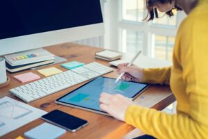 Designer woman drawing a website outline and website due diligence ux app development on mobile phone.